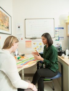 Nutritionist speaking with patient in clinic